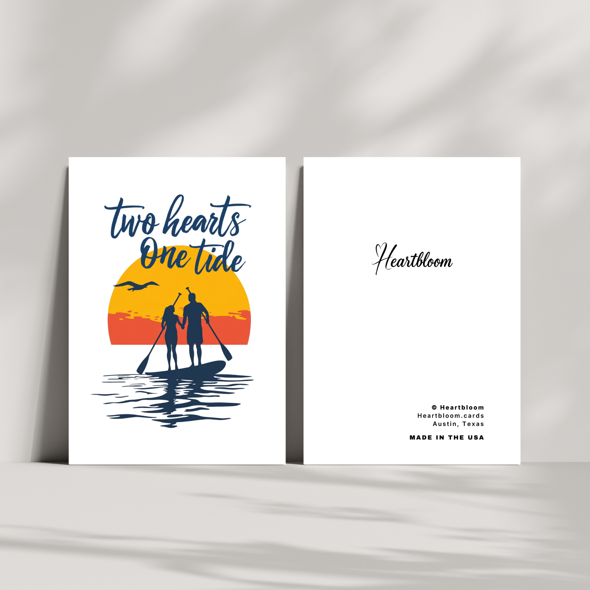 Two cards with a sunset design and 'two hearts one tide' text on a white background.