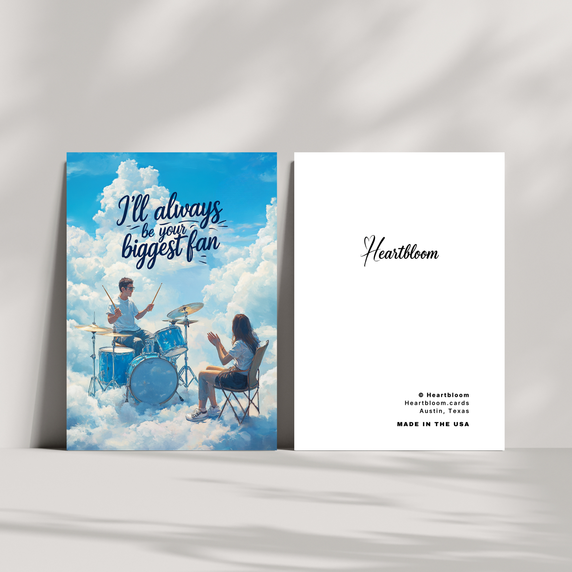 Card with illustration of two people in the clouds and 'I'll always be your biggest fan' text, with Heartbloom branding.