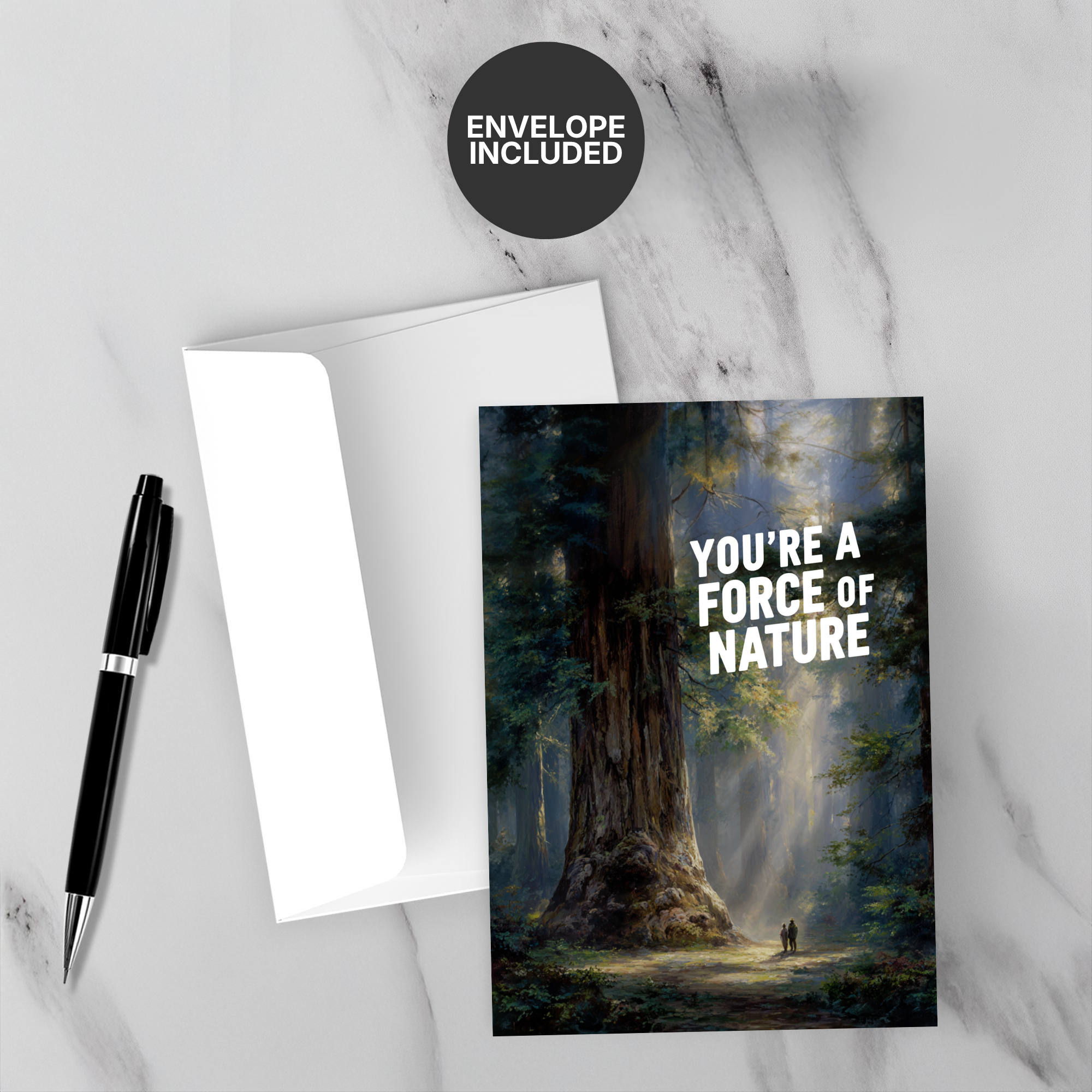 Greeting card with tree design and 'You're a Force of Nature' text on a marble surface with a pen and envelope.