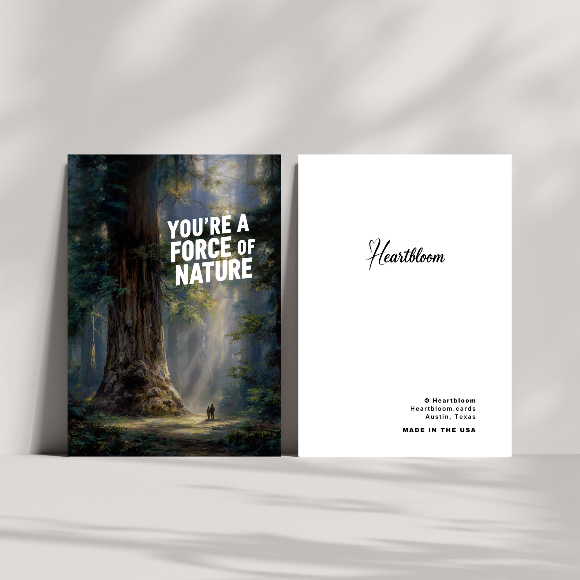 Card with a forest scene and text 'You're a Force of Nature' by Heartbloom on a white wall.