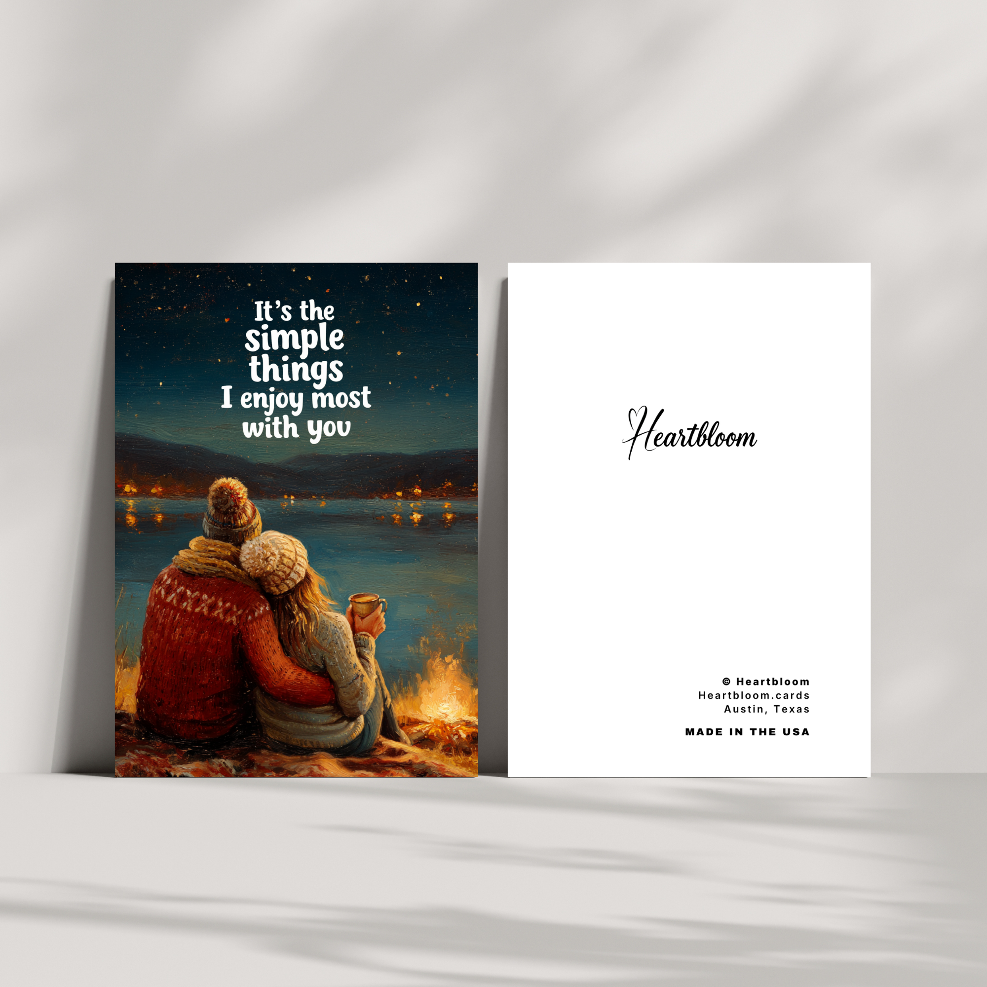 Heartbloom card with a couple by a campfire and text 'It's the simple things I enjoy most with you' on a white background.