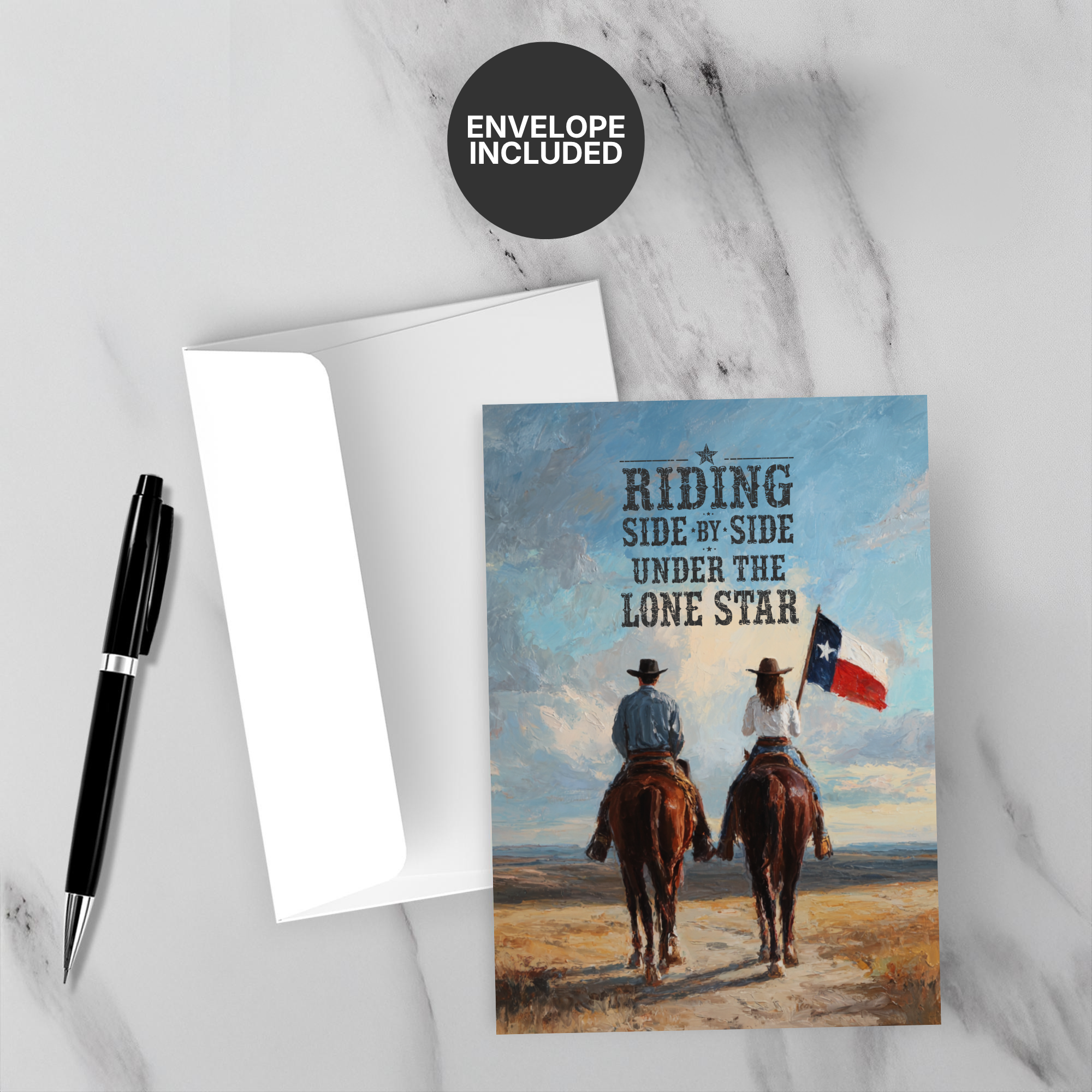Greeting card with two people on horses and a Texas flag, accompanied by an envelope and pen on a marble surface.