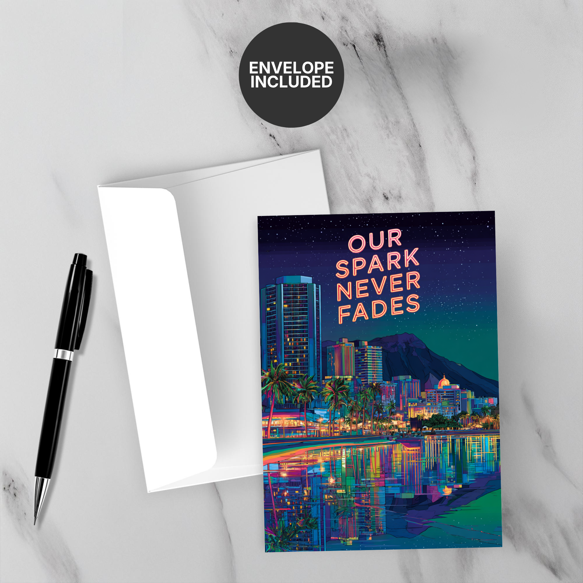 Greeting card with cityscape design and 'Our Spark Never Fades' text on a marble surface with a pen and envelope.
