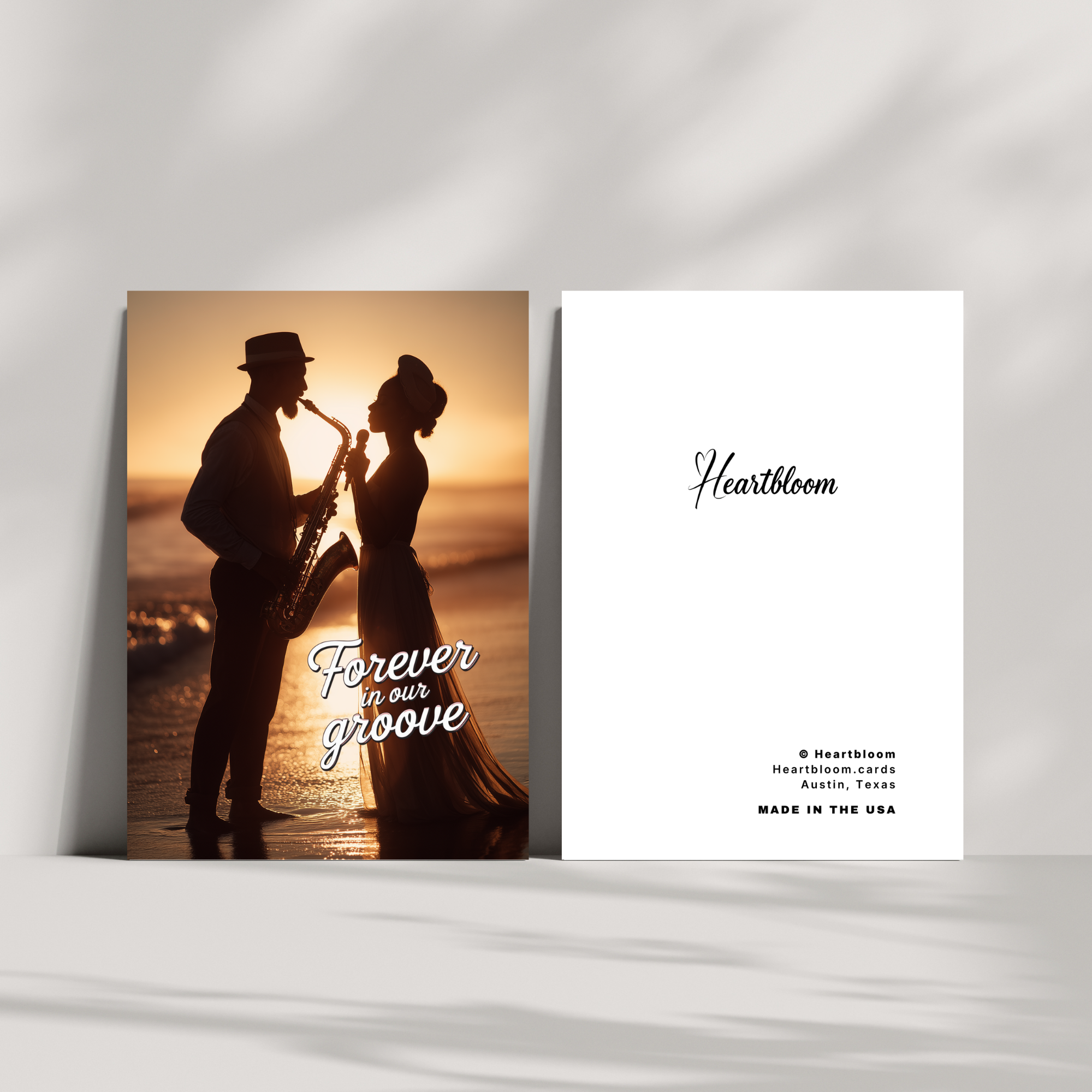 Card with silhouette of a couple on a beach with 'Heartbloom' branding and text.