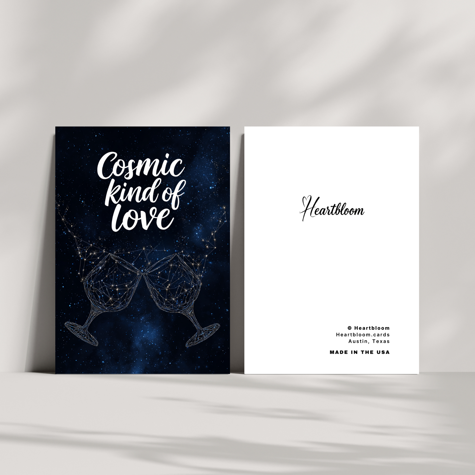 Two greeting cards with 'Cosmic kind of love' design and 'Heartbloom' branding on a white background.
