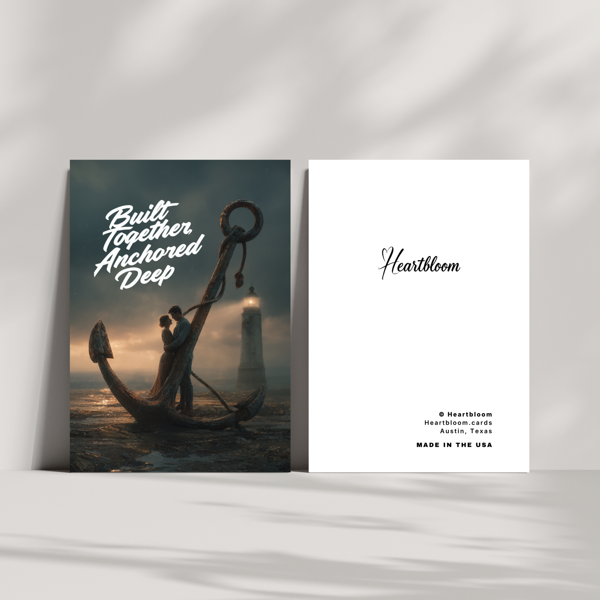 Heartloom card with romantic illustration of a couple on an anchor and text 'Built Together Anchored Deep' against a white background.