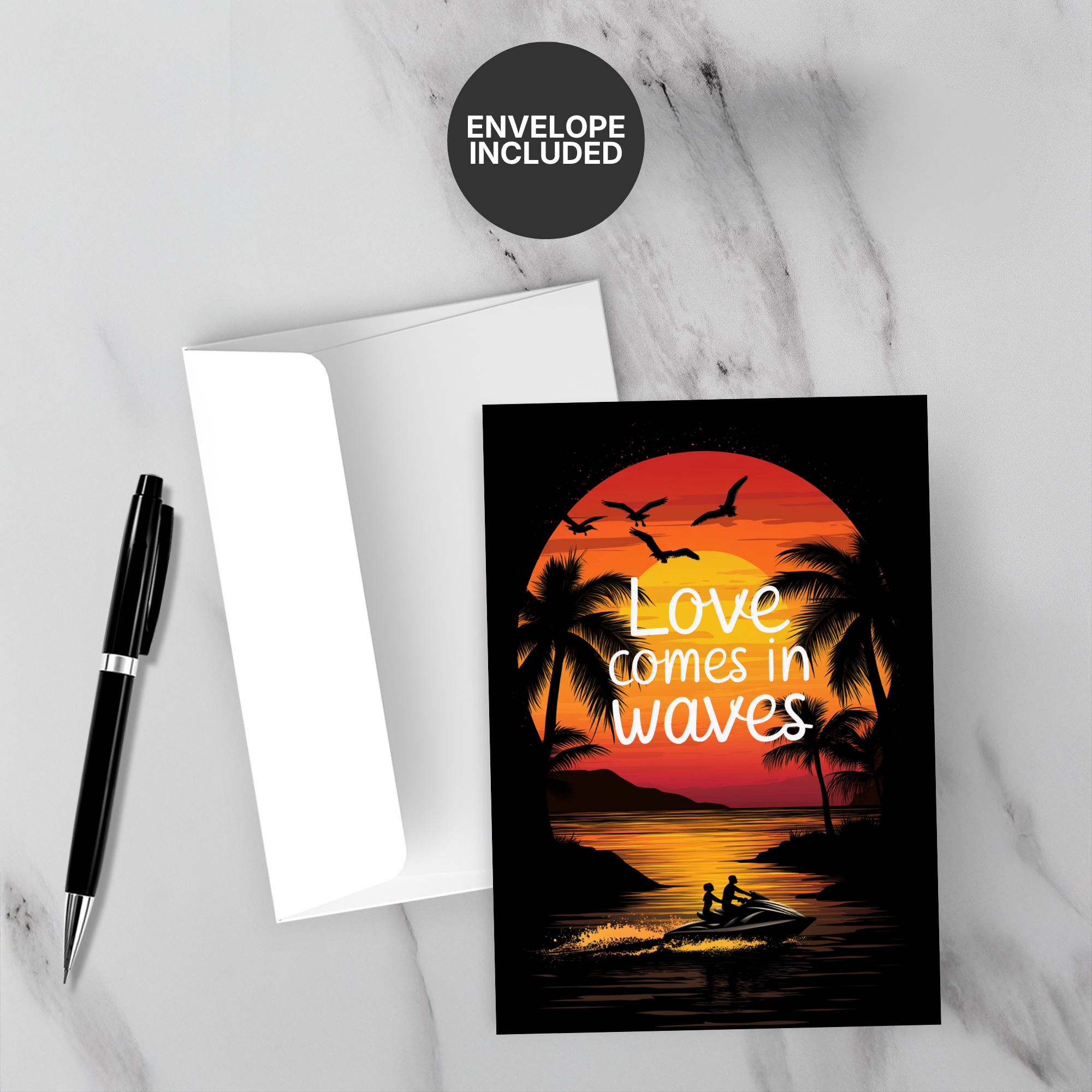 Greeting card with sunset design and 'Love comes in waves' text on a marble surface with a pen and envelope.