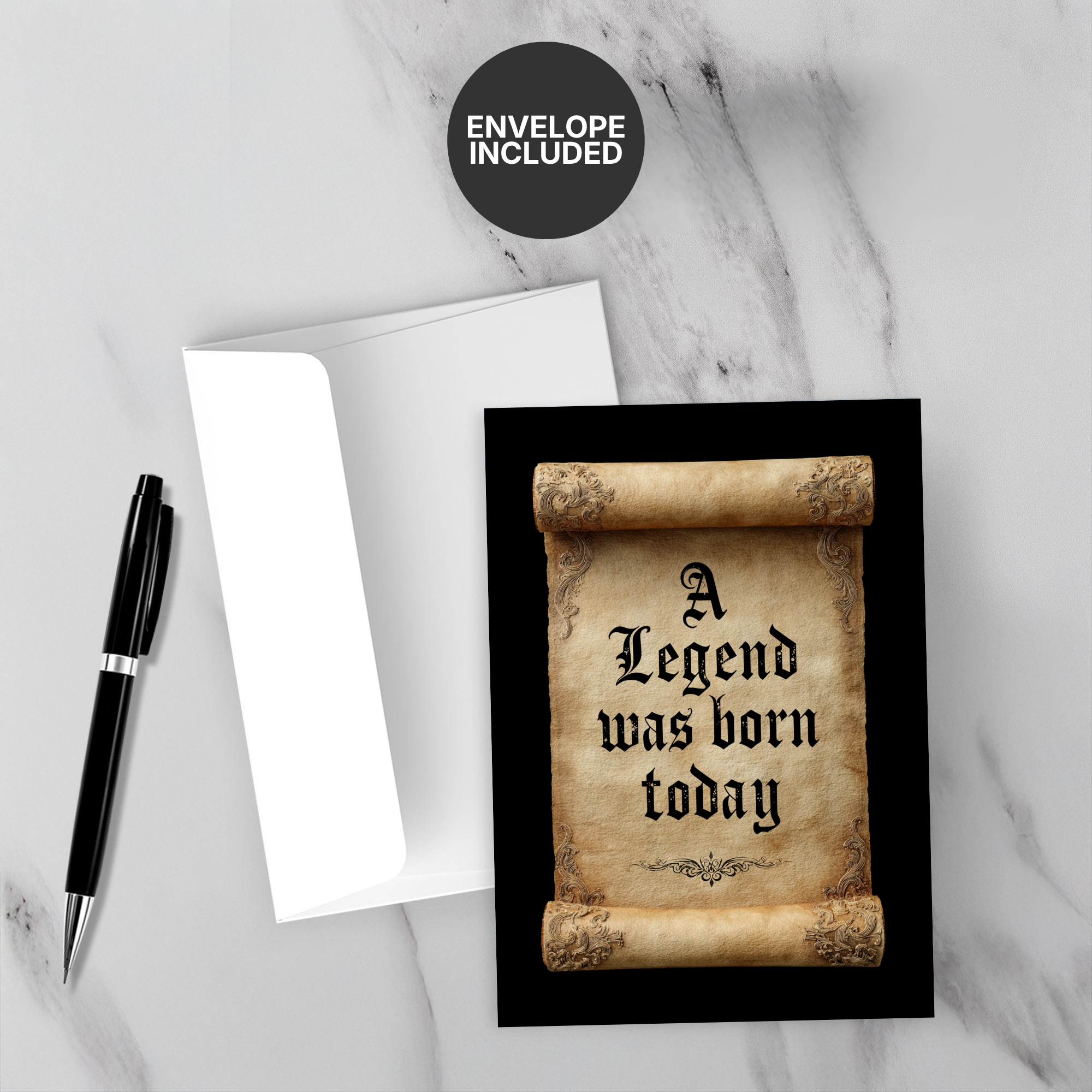 Birthday card with 'A Legend was born today' text on a marble surface with a pen and envelope.