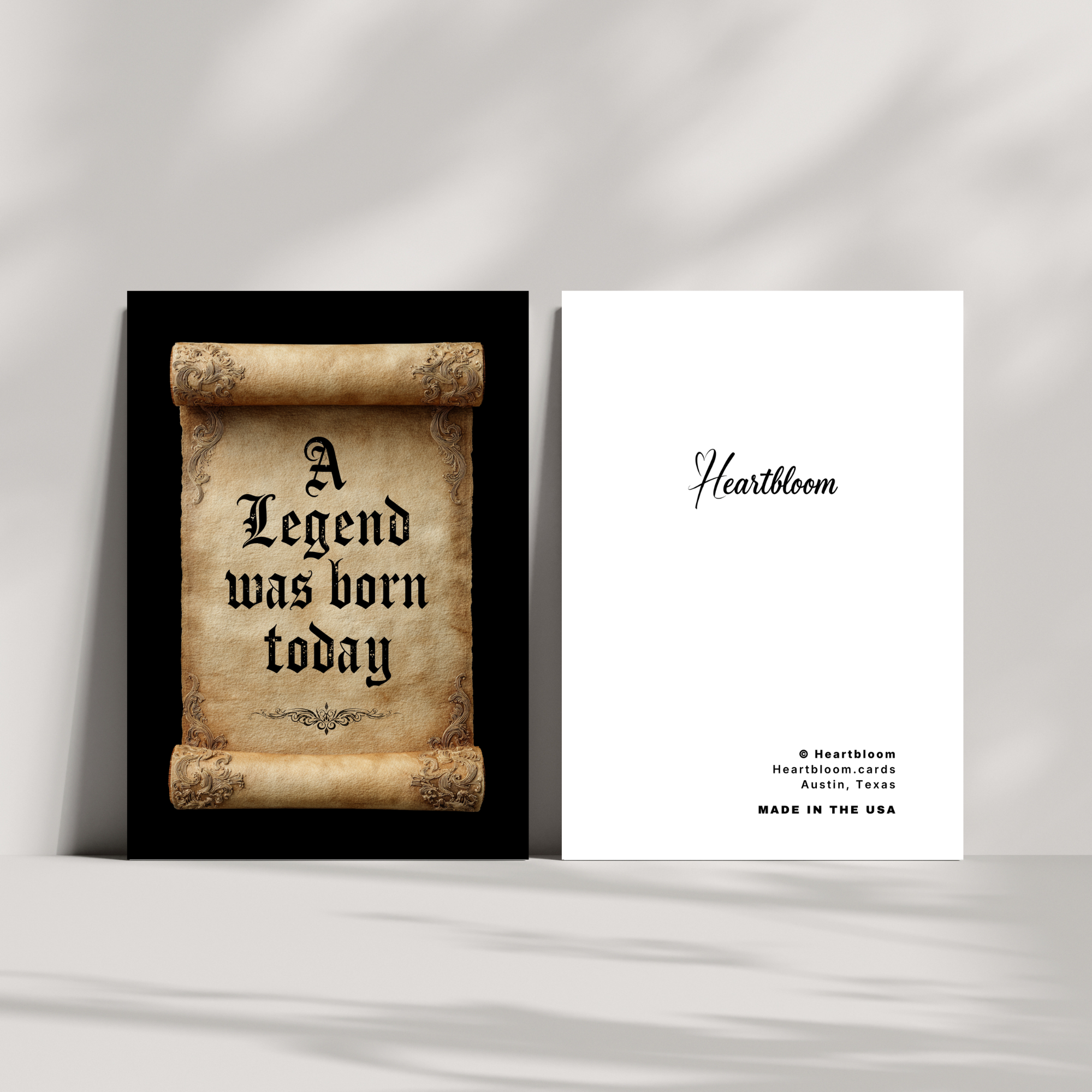 Birthday card with text 'A Legend was born today' and a card with 'Heartbloom' branding on a gray background.