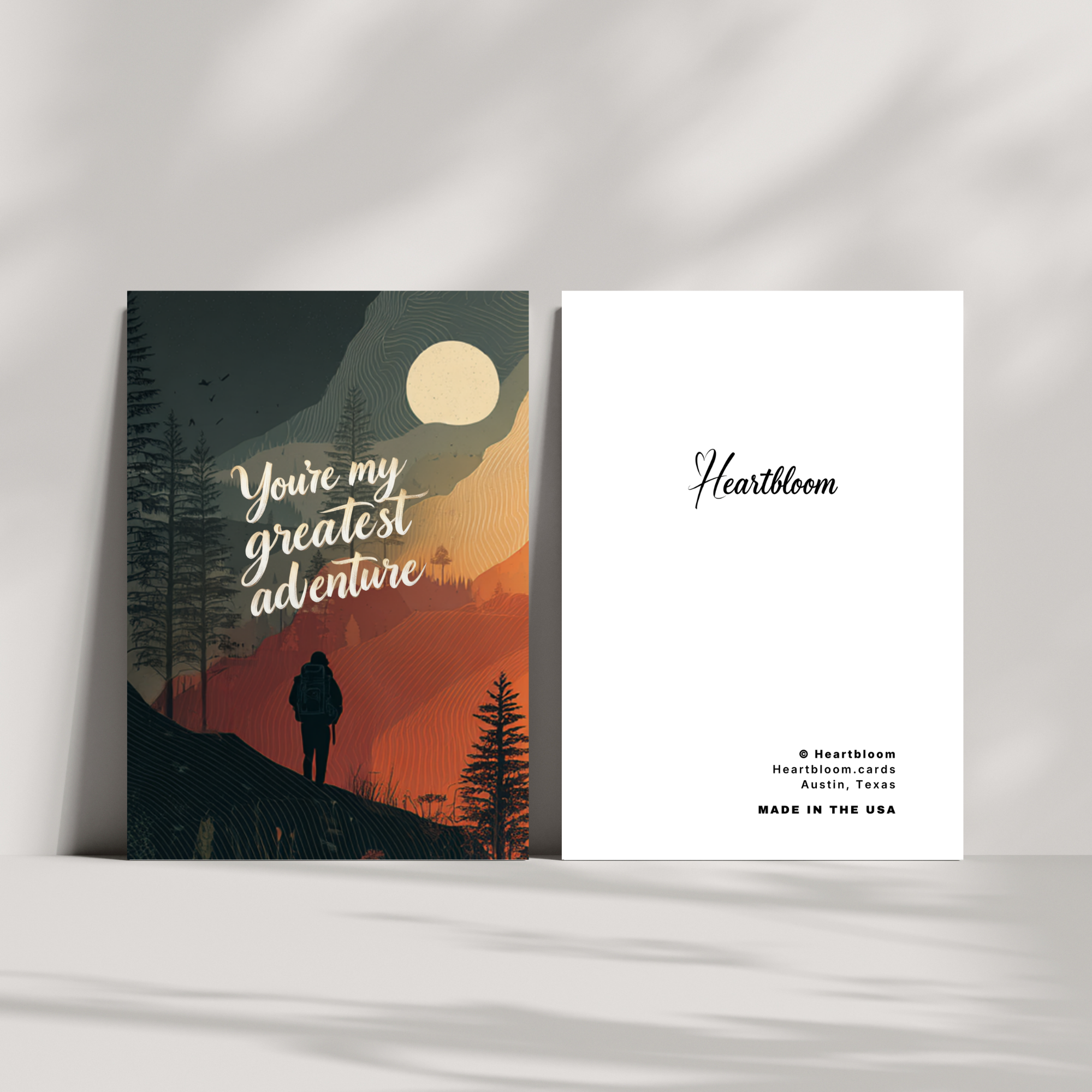 Two greeting cards with a scenic design and 'Heartbloom' branding on a white surface.