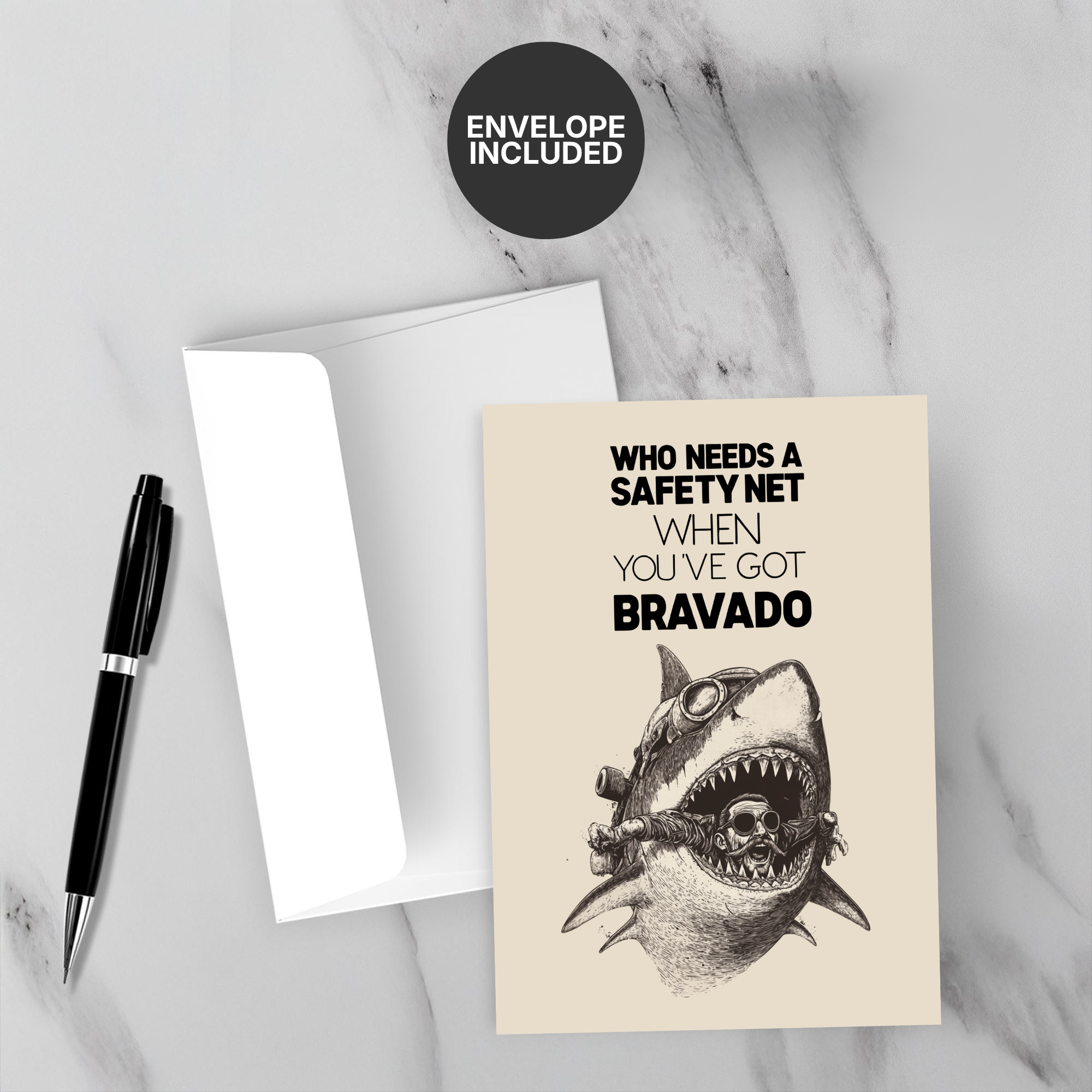 Greeting card with shark illustration and text on a marble surface with a pen and envelope.