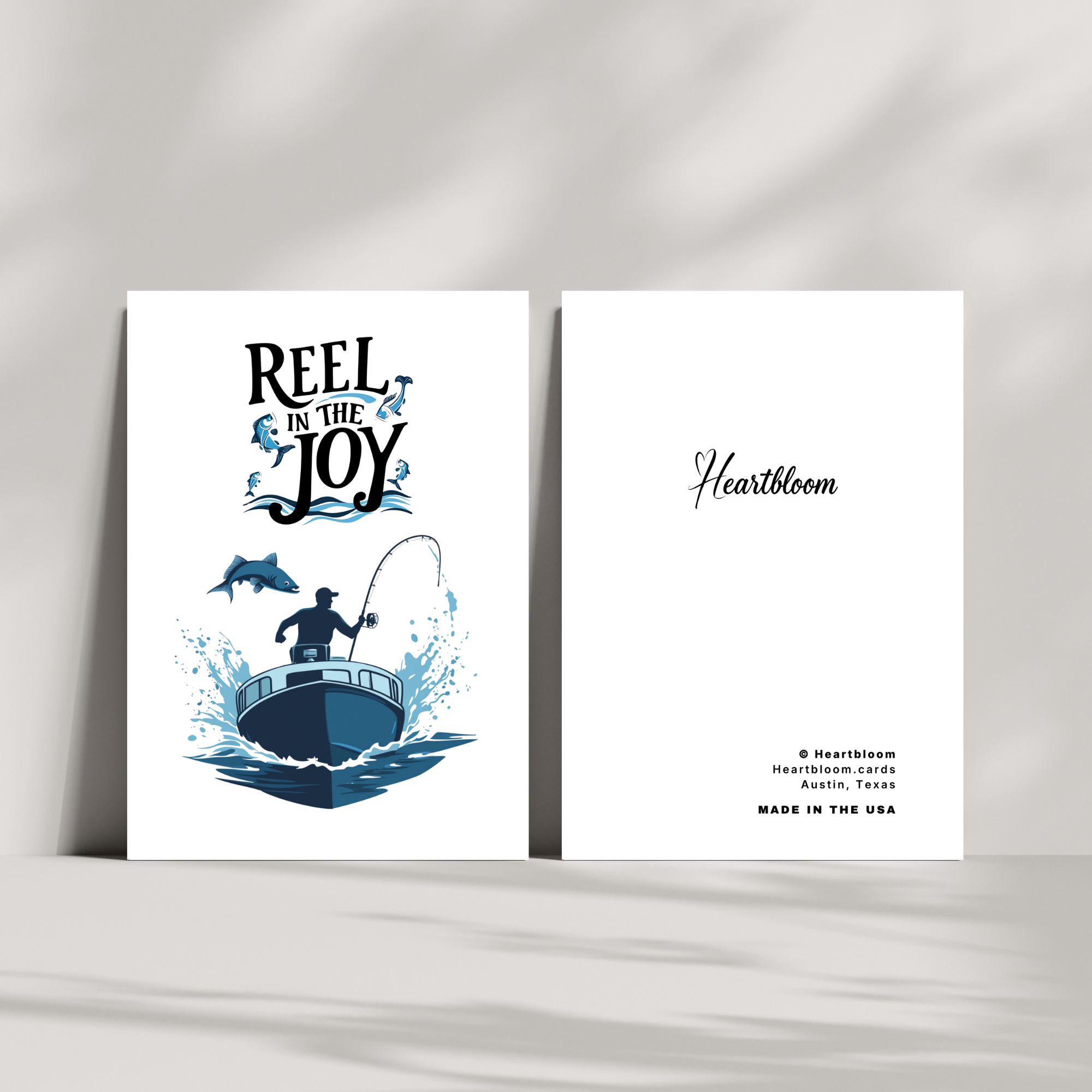 Greeting card with fishing design and 'Reel in the Joy' text on a white background