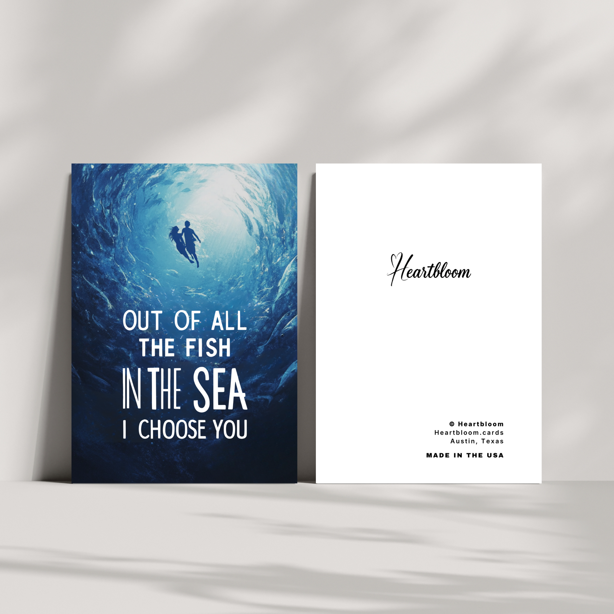 Cards with a romantic design and text on a white surface.