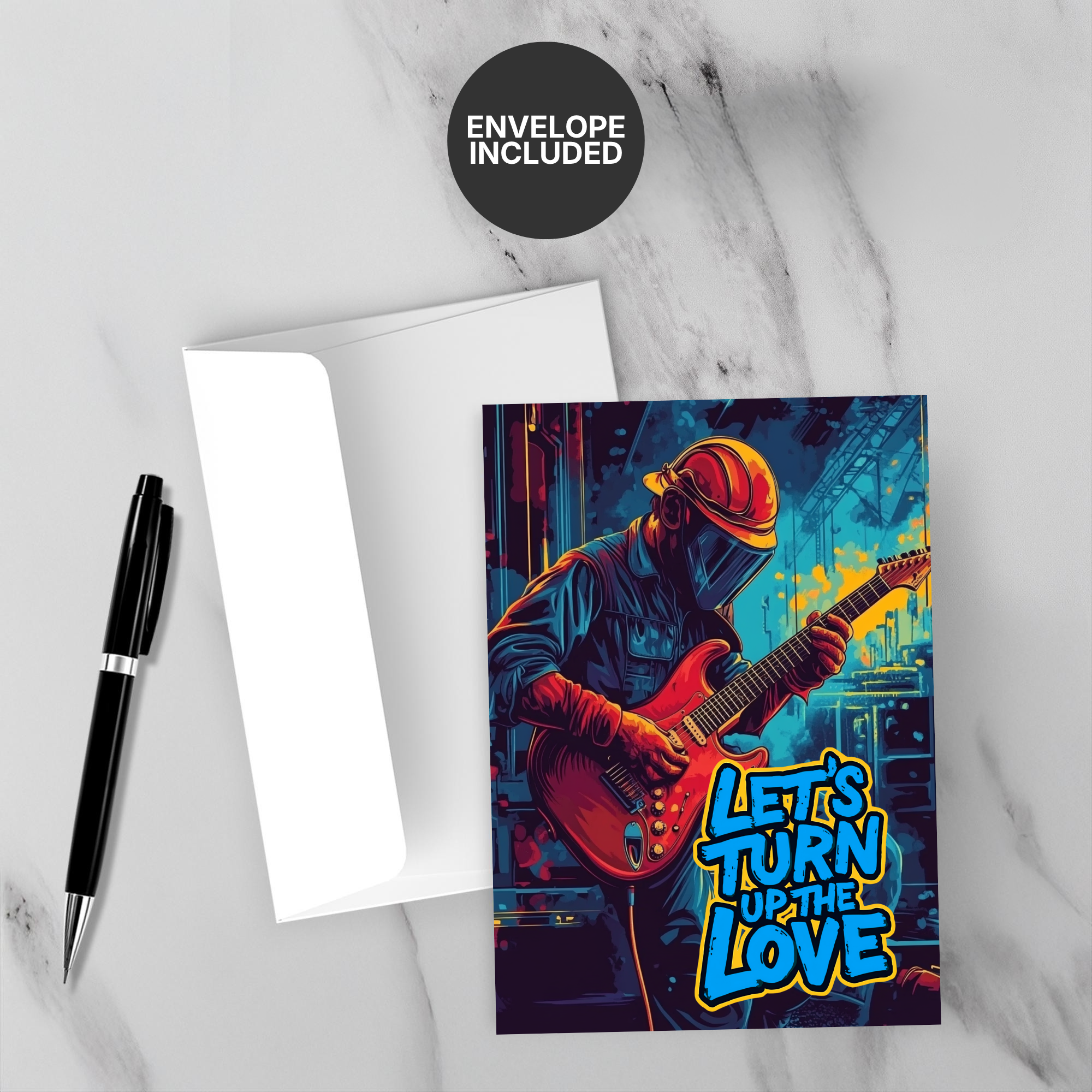 Greeting card with a musician playing guitar and text 'Let's Turn Up the Love' on a marble surface with a pen and envelope.