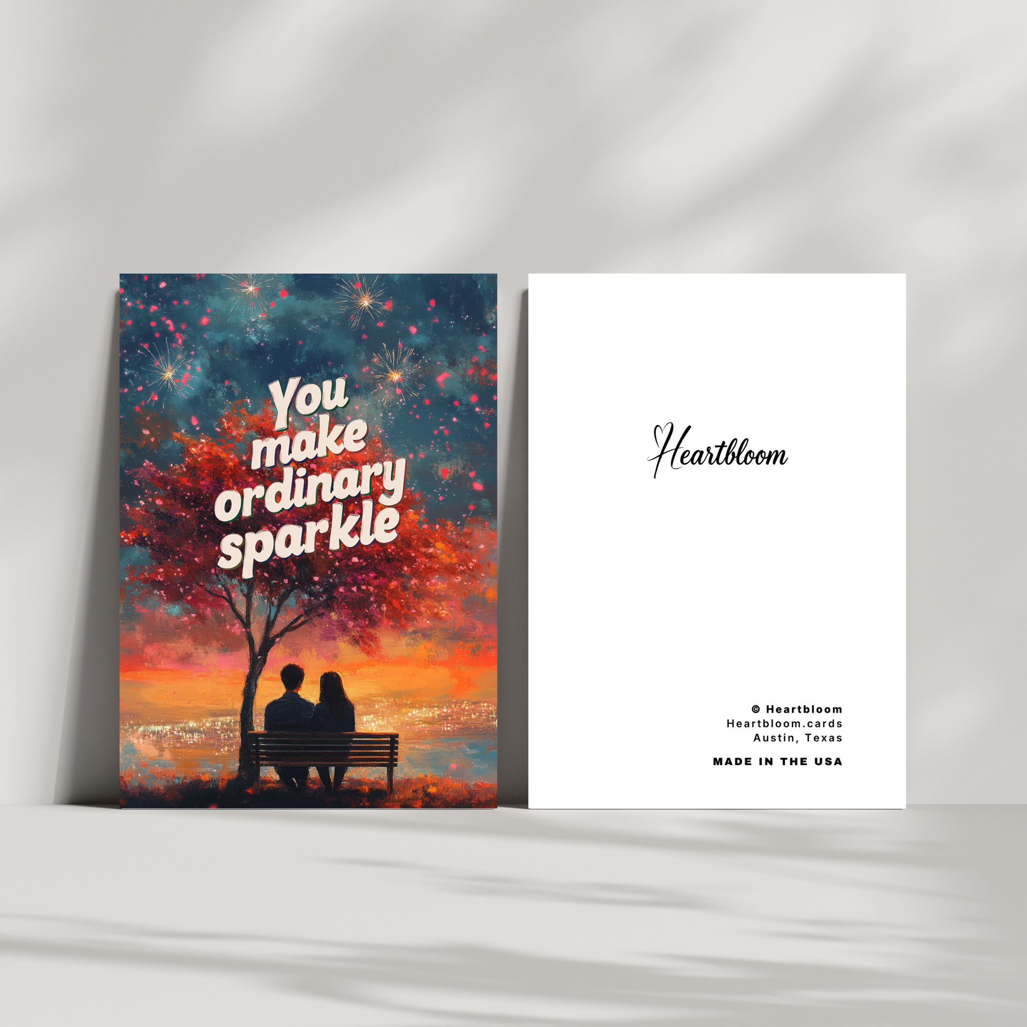 Card with a couple under a tree at sunset and 'You make ordinary sparkle' text, with Heartbloom branding.