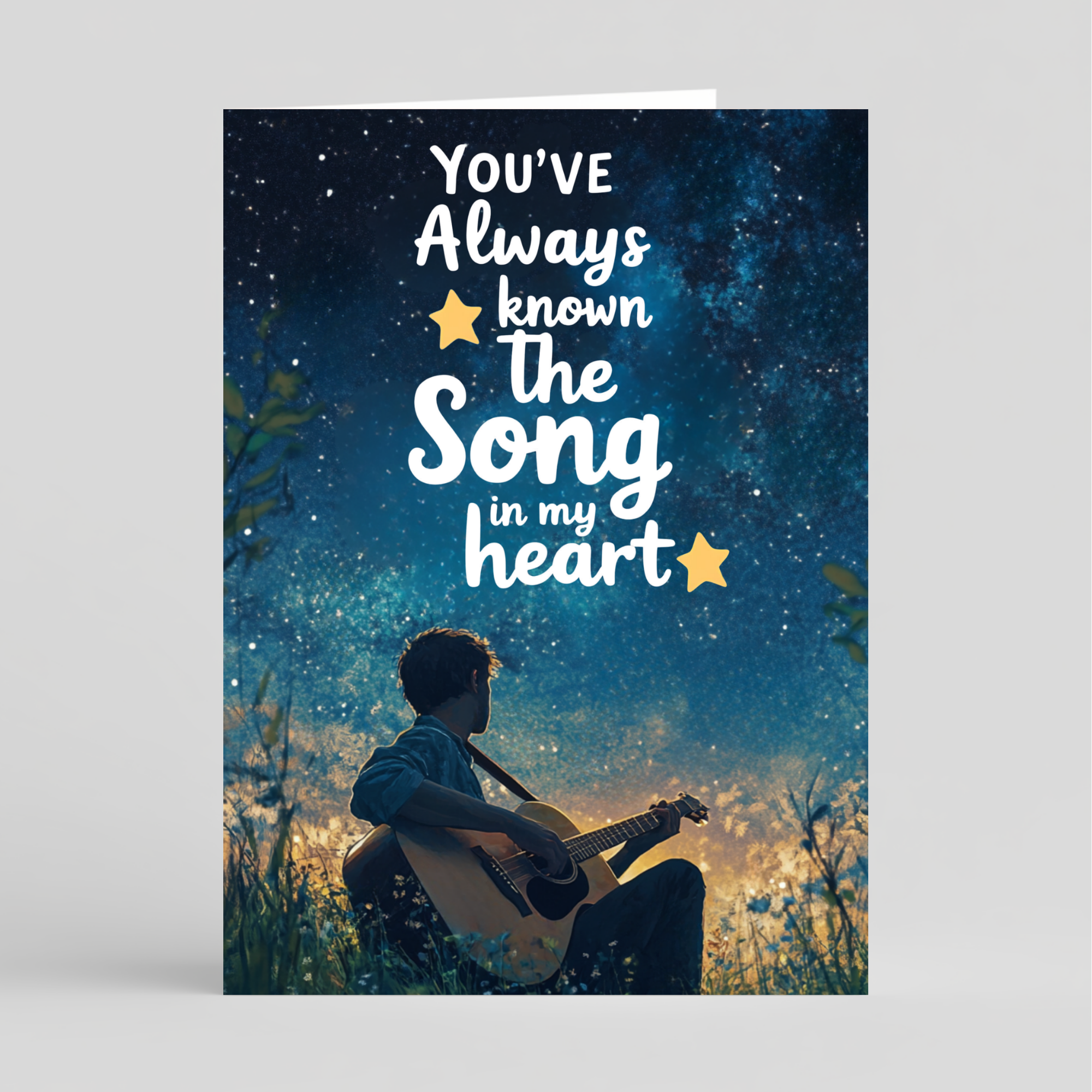 Card with a person playing guitar against a starry night sky, featuring the text 'You've Always Known the Song in My Heart'.