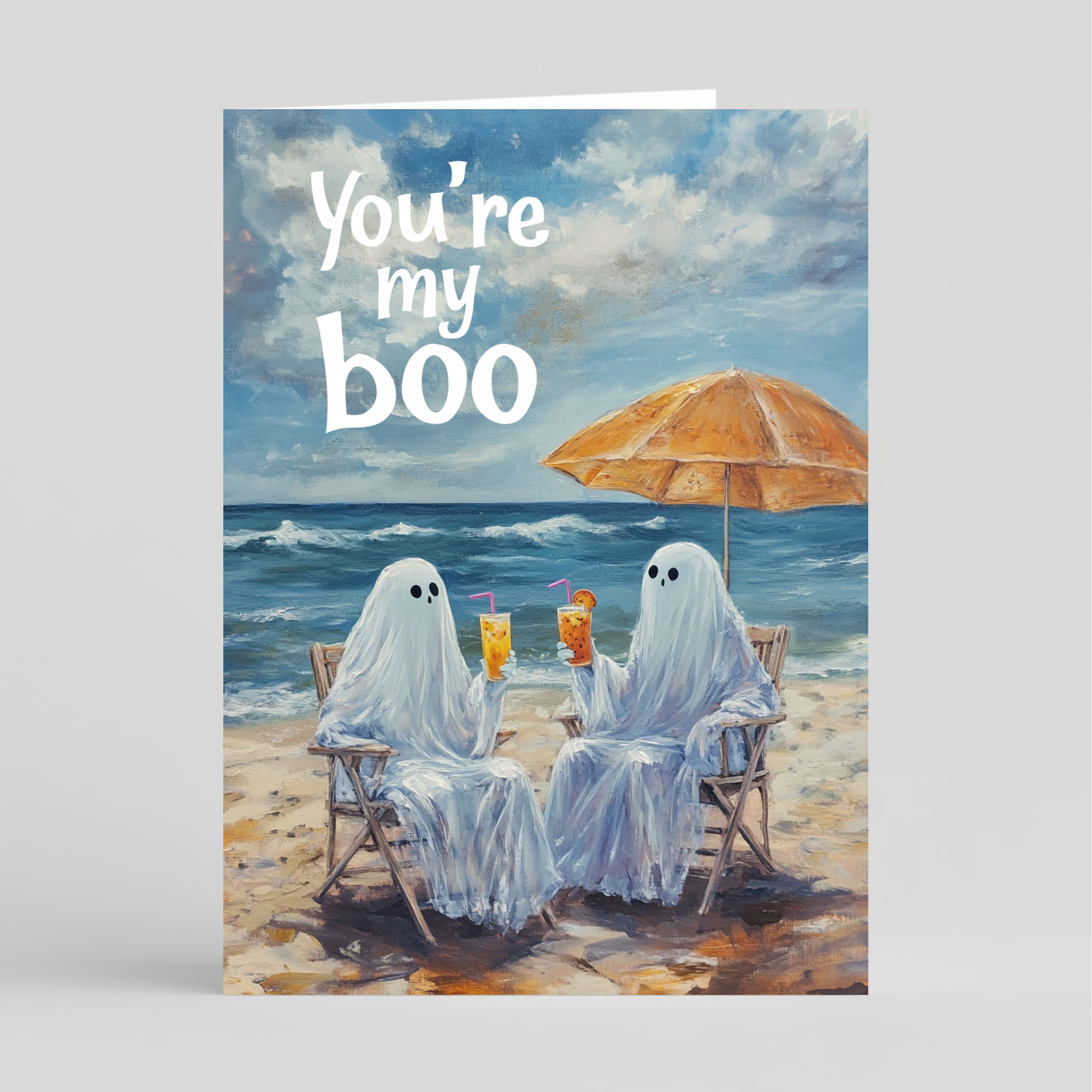 Card of two ghosts on a beach with an umbrella and drinks, with text 'You're my boo' above.