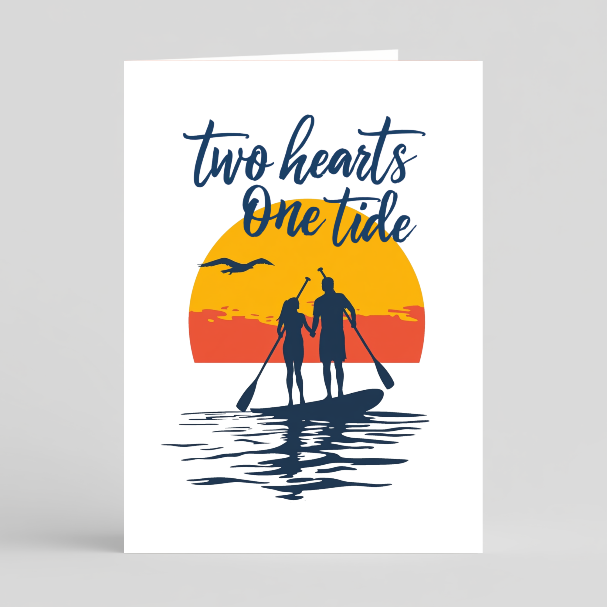 Card with 'Two hearts One tide' text, sunset design, and silhouettes of a couple on a paddleboard.