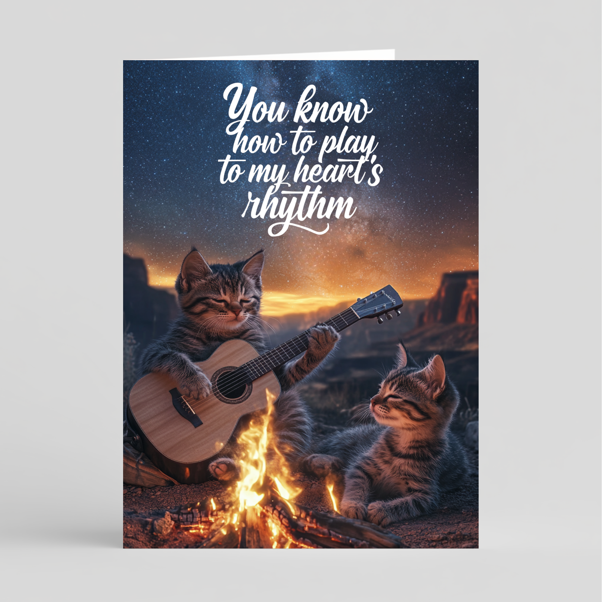 Two cats playing guitar by a campfire with a romantic quote against a starry sky.